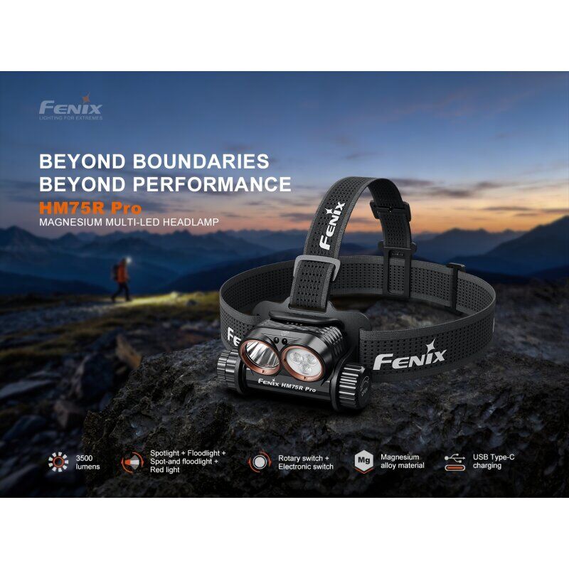 Die Fenix HM75R Pro Magnesium Multi-LED Stirnlampe auf einem dunklen Felsen vor einer Berglandschaft.
