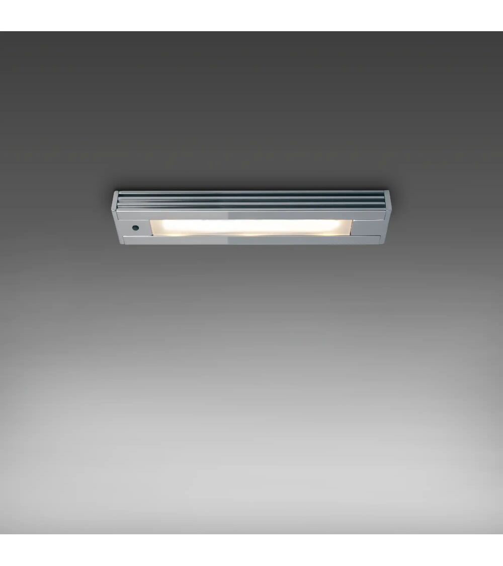 Die LED-Unterbauleuchte UB02 von Prebit in Gold-Glanz leuchtet warmweiß an einer Decke.